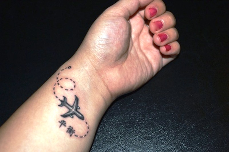 Black Airplane Tattoo On Wrist