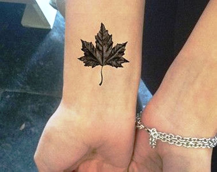 Black And Grey Maple Leaf Tattoo On Wrist