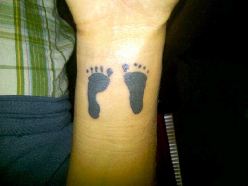 Black Baby Footprint Tattoo On Wrist