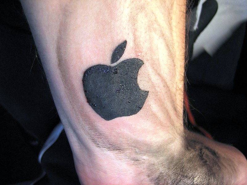 Black Ink Apple Logo Tattoo On Wrist