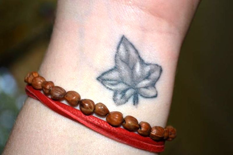 Black Maple Leaf Tattoo On Wrist