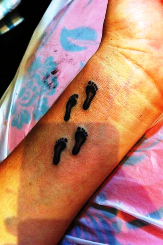 Brilliant Footprints Tattoo On Wrist