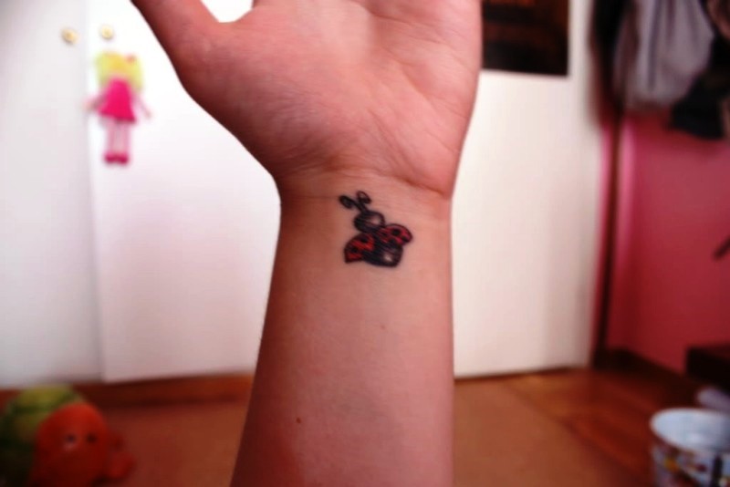 Cute Flying Ladybug Wrist Tattoo