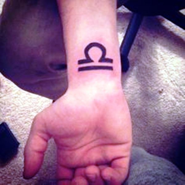 Large Libra Tattoo On Wrist