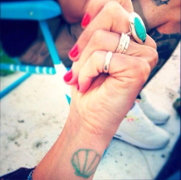 Nice Green Seashell Tattoo On Wrist